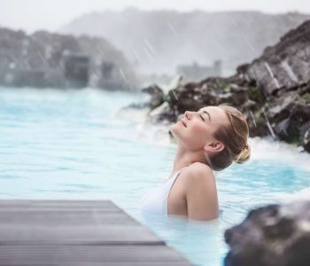 Woman enjoying natural spa, Blue Lagoon is a geothermal spa in southwestern Iceland, is located in a lava field near Grindavk on the Reykjanes Peninsula